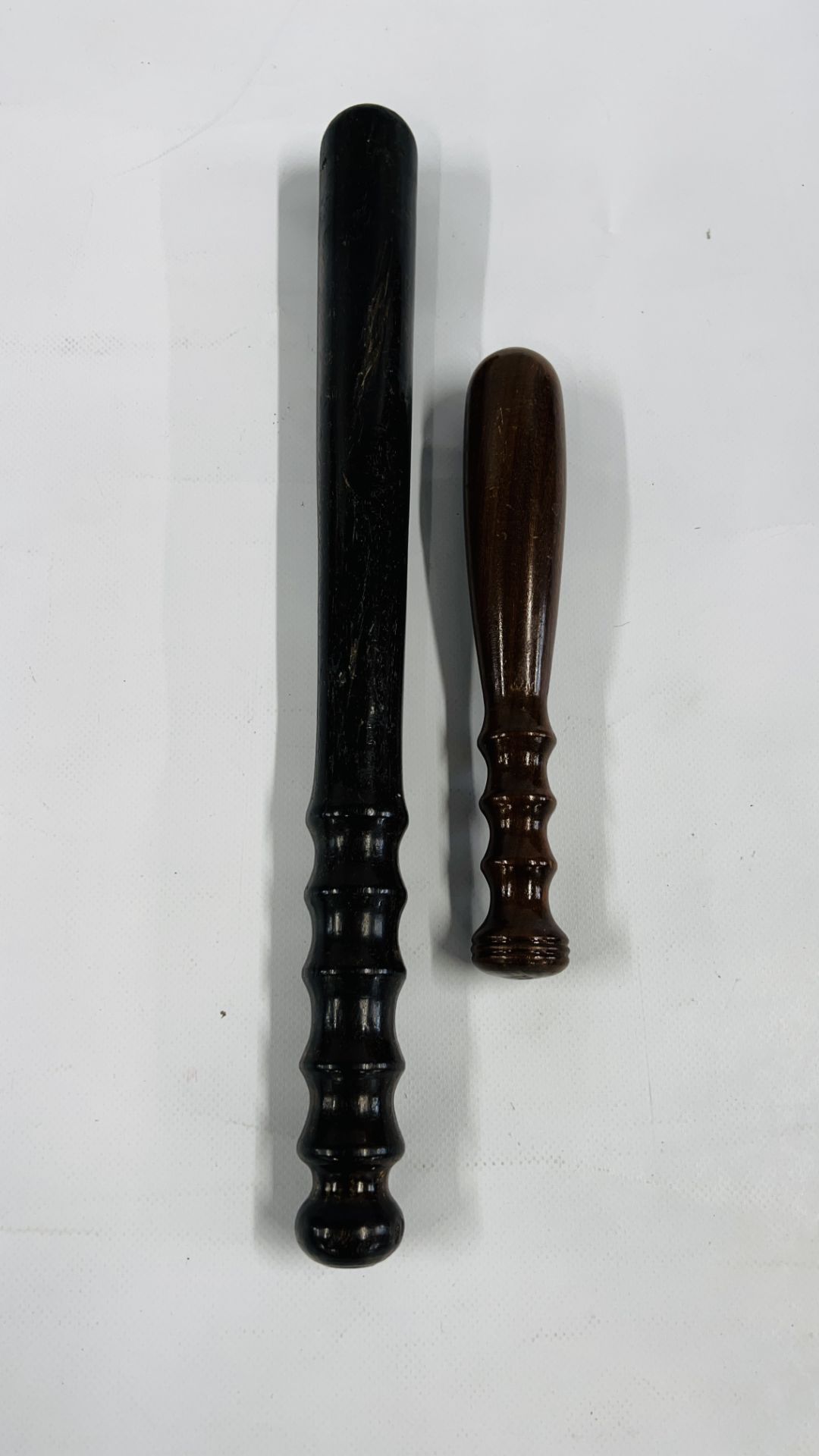 TWO VINTAGE TRUNCHEONS L 21.5CM X L 39.5CM.