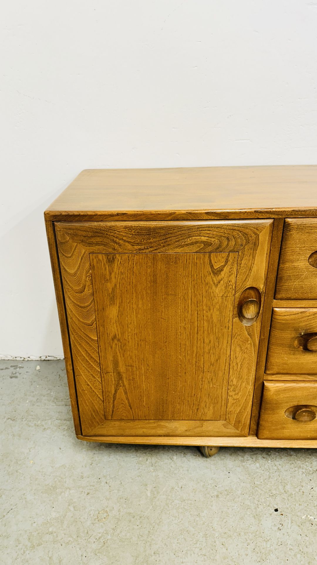 ERCOL WINDSOR 3 DRAWER 2 DOOR SIDEBOARD ON CASTERS - W 155CM X D 44CM X H 69CM. - Image 8 of 13