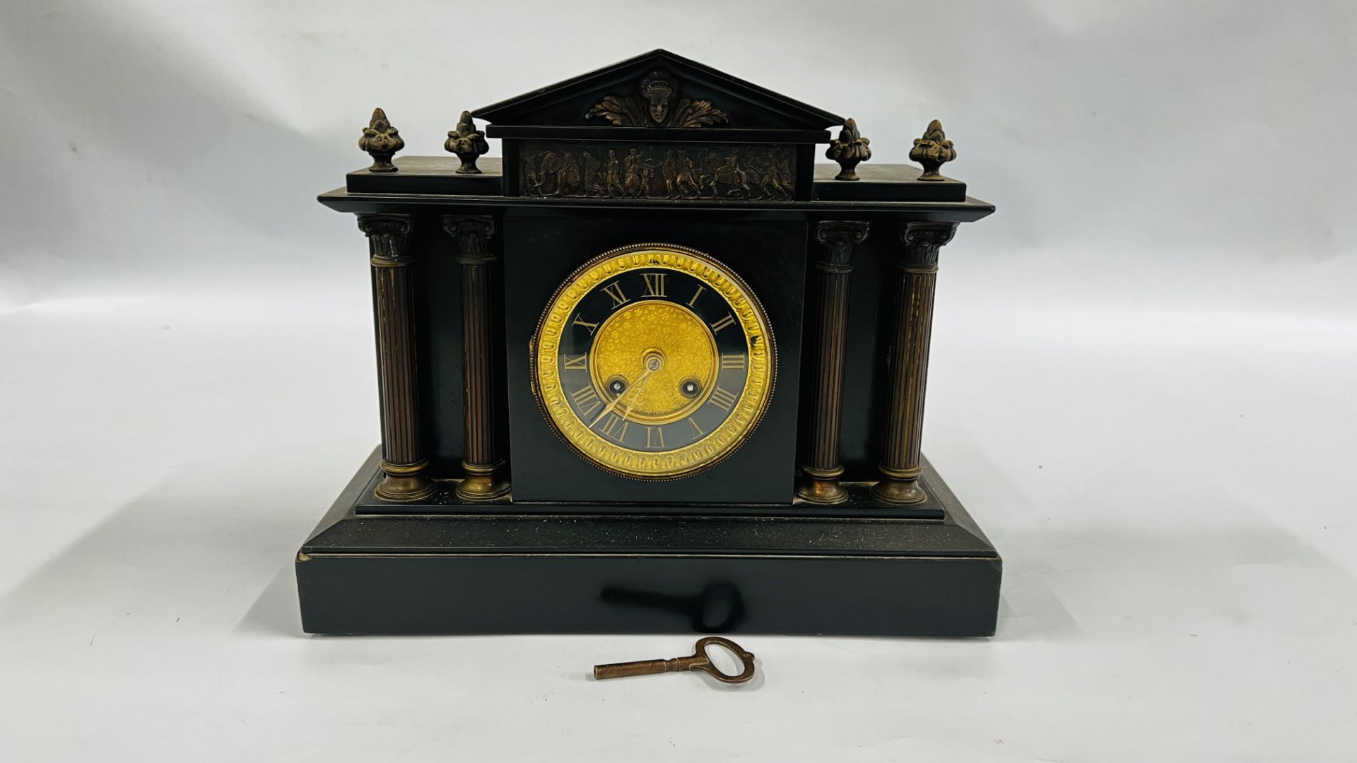 A SLATE MANTEL TIMEPIECE, THE CLOCK CASE EMBELLISHED WITH FIGURES, ANIMALS AND COLUMN DETAIL,