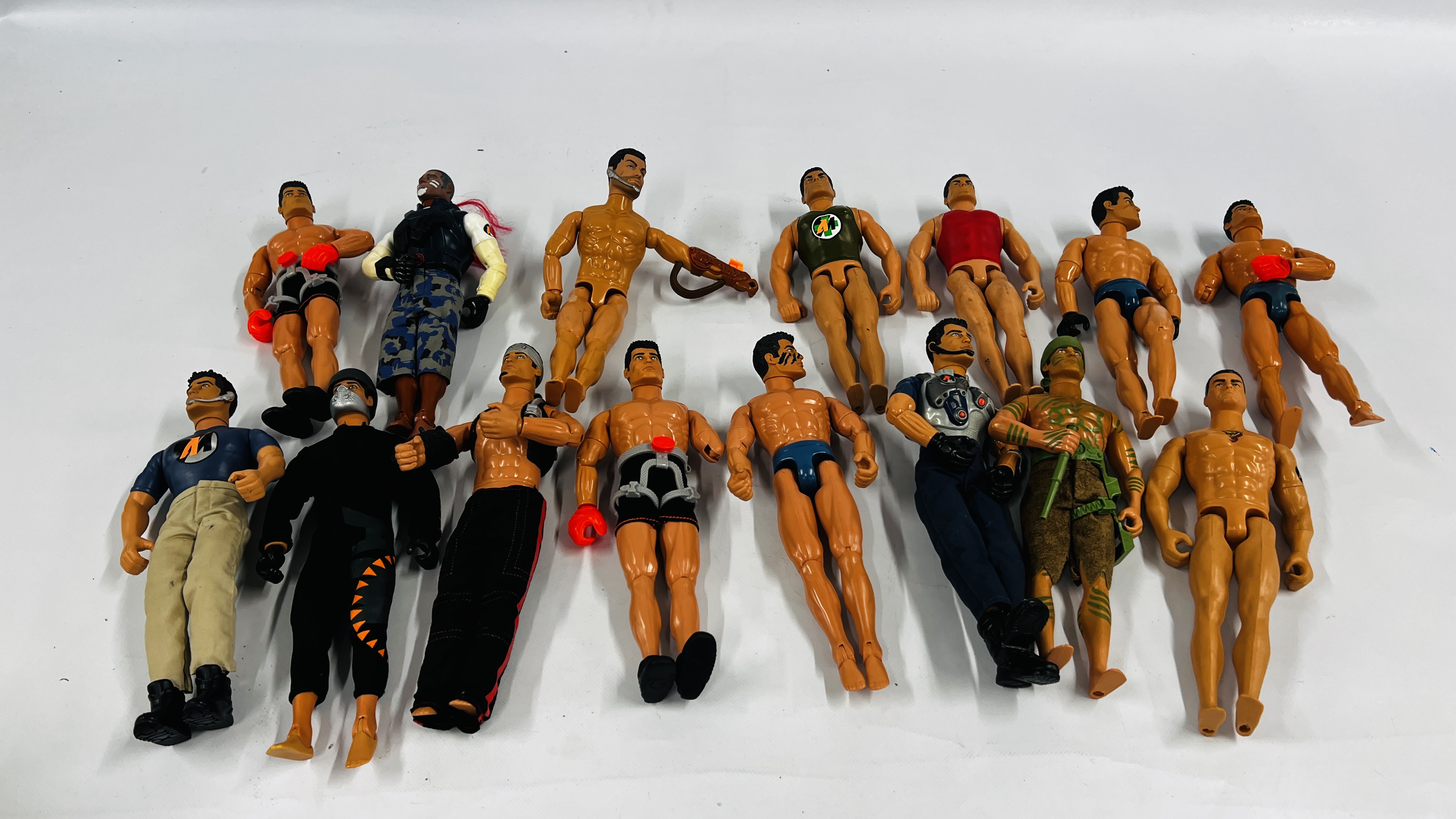 A BOX CONTAINING A GROUP OF 15 ASSORTED ACTION MAN FIGURES IN VARIOUS OUTFITS.