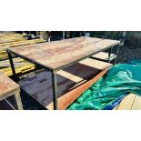 A HEAVY DUTY STEEL FRAMED WORK BENCH 122 X 244CM. THIS LOT IS SUBJECT TO VAT ON HAMMER PRICE.