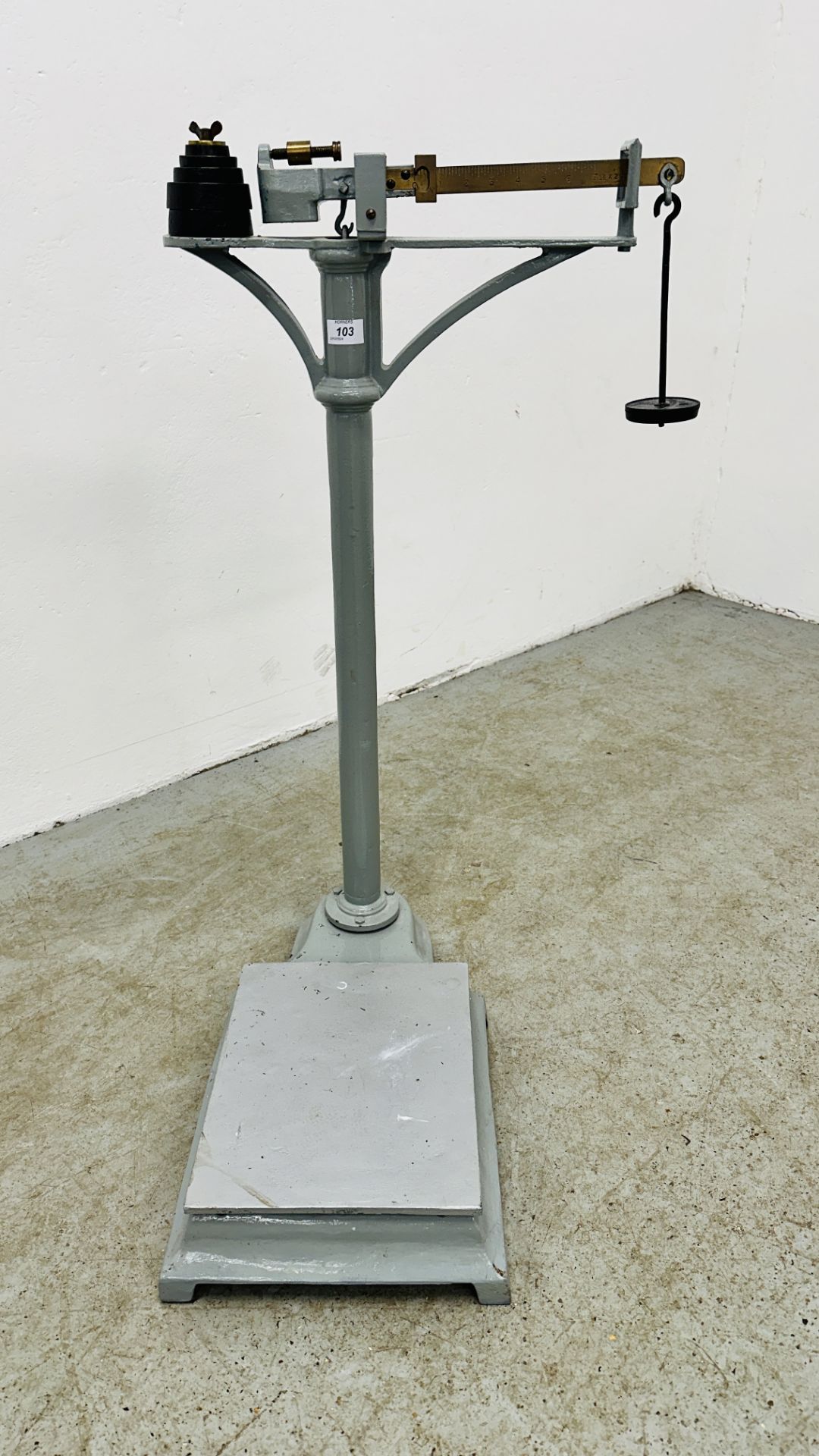 A SET OF LARGE WEIGHT SCALES WITH WEIGHTS.