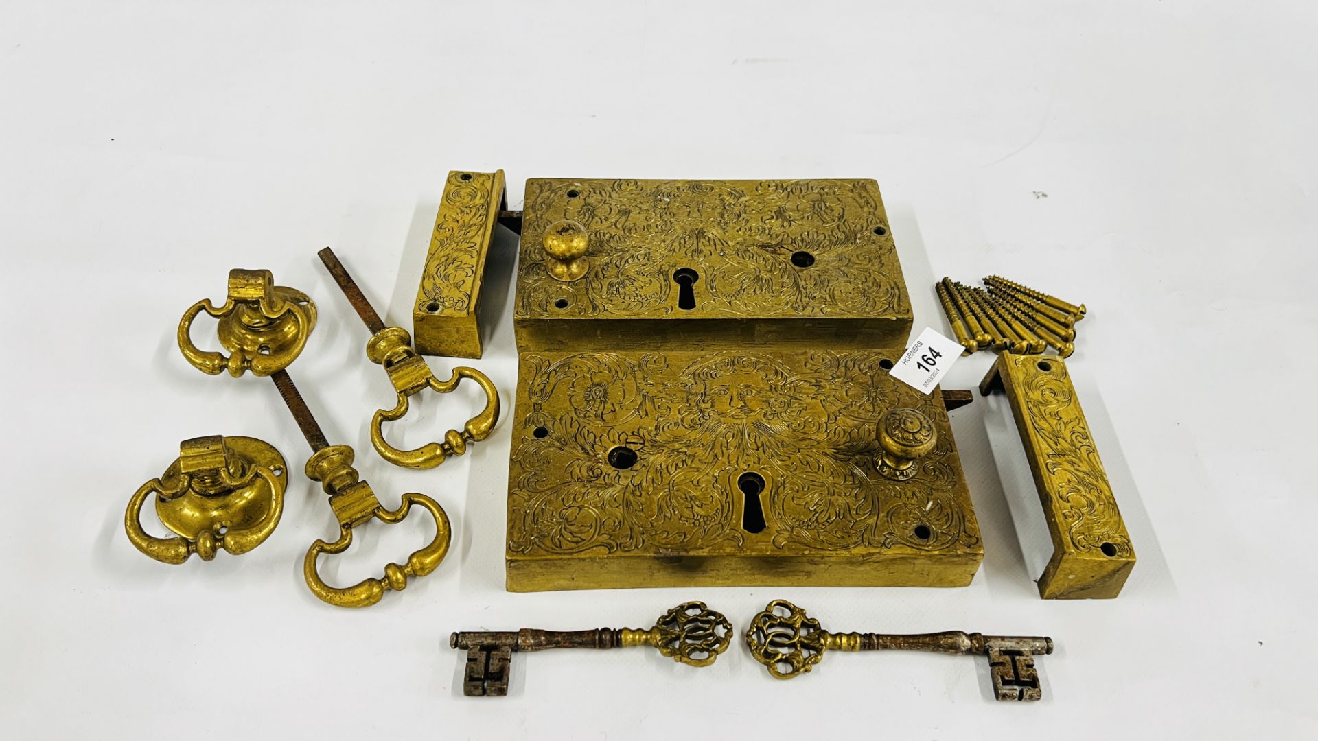 A PAIR OF ELABORATE ANTIQUE SOLID BRASS DOOR LOCKS PROBABLY C18th RETAINING THE ORIGINAL KEYS,