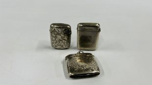A GROUP OF THREE SILVER MATCHBOX STRIKERS TO INCLUDE ENGRAVED AND ENGINE TURNED EXAMPLES.