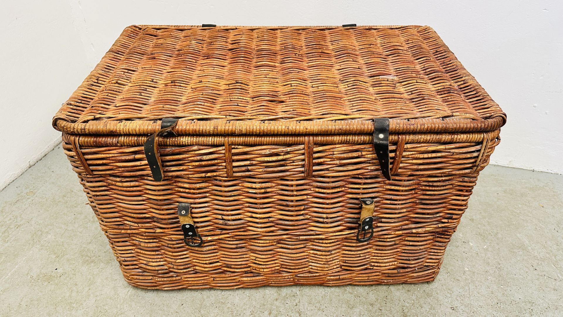 A LARGE WICKER TWO HANDLED BASKET - W 90 X D 55 X H 55CM.