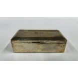 A VINTAGE SILVER CIGARETTE BOX BIRMINGHAM ASSAY J.H.W (RUBBED MARKS) BEARING MONOGRAM MJ 24.7.