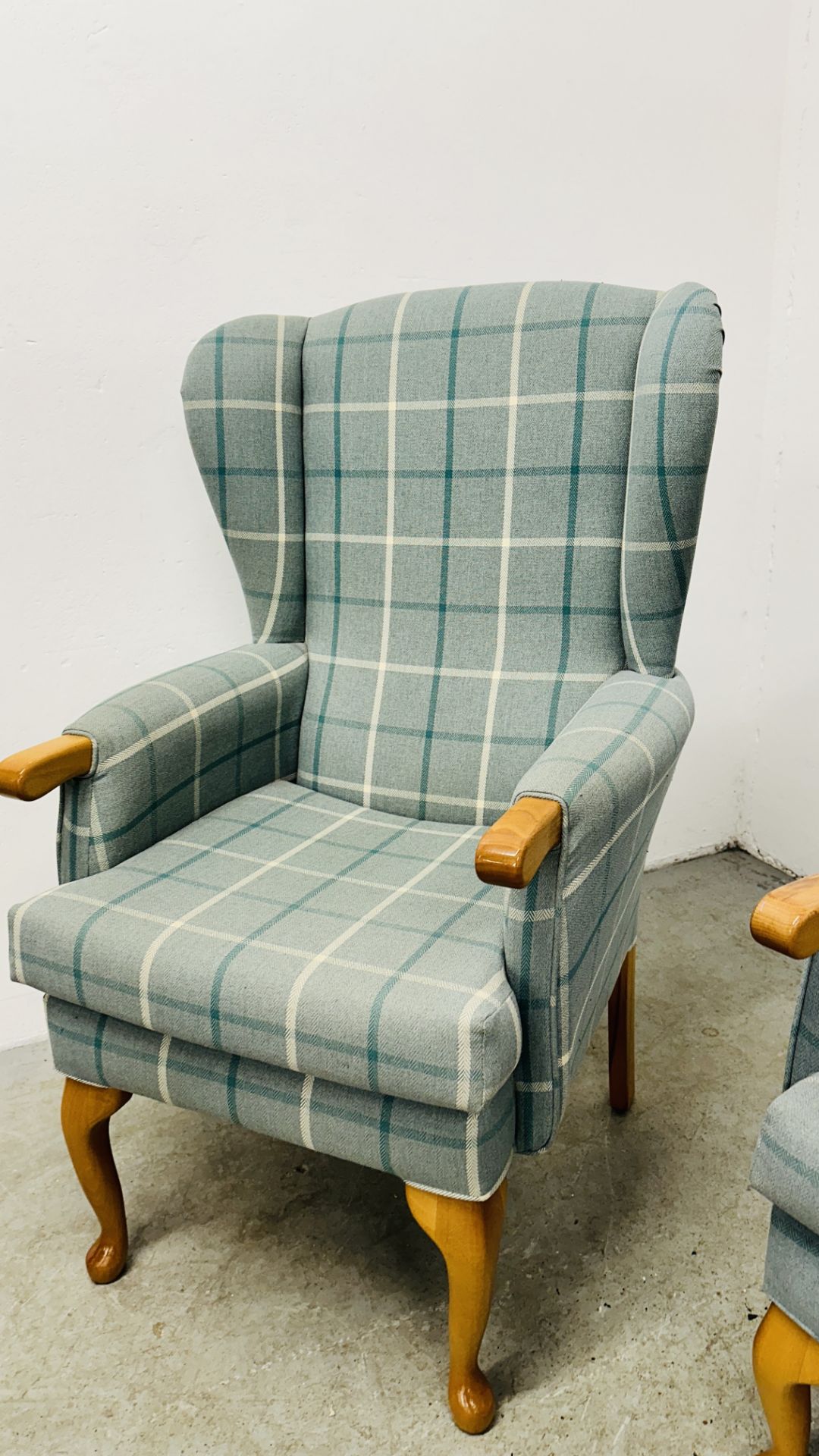 A HIS & HERS SET OF MODERN BLUE CHECKERED UPHOLSTERED BEECH WOOD WING BACK CHAIRS. - Image 9 of 17