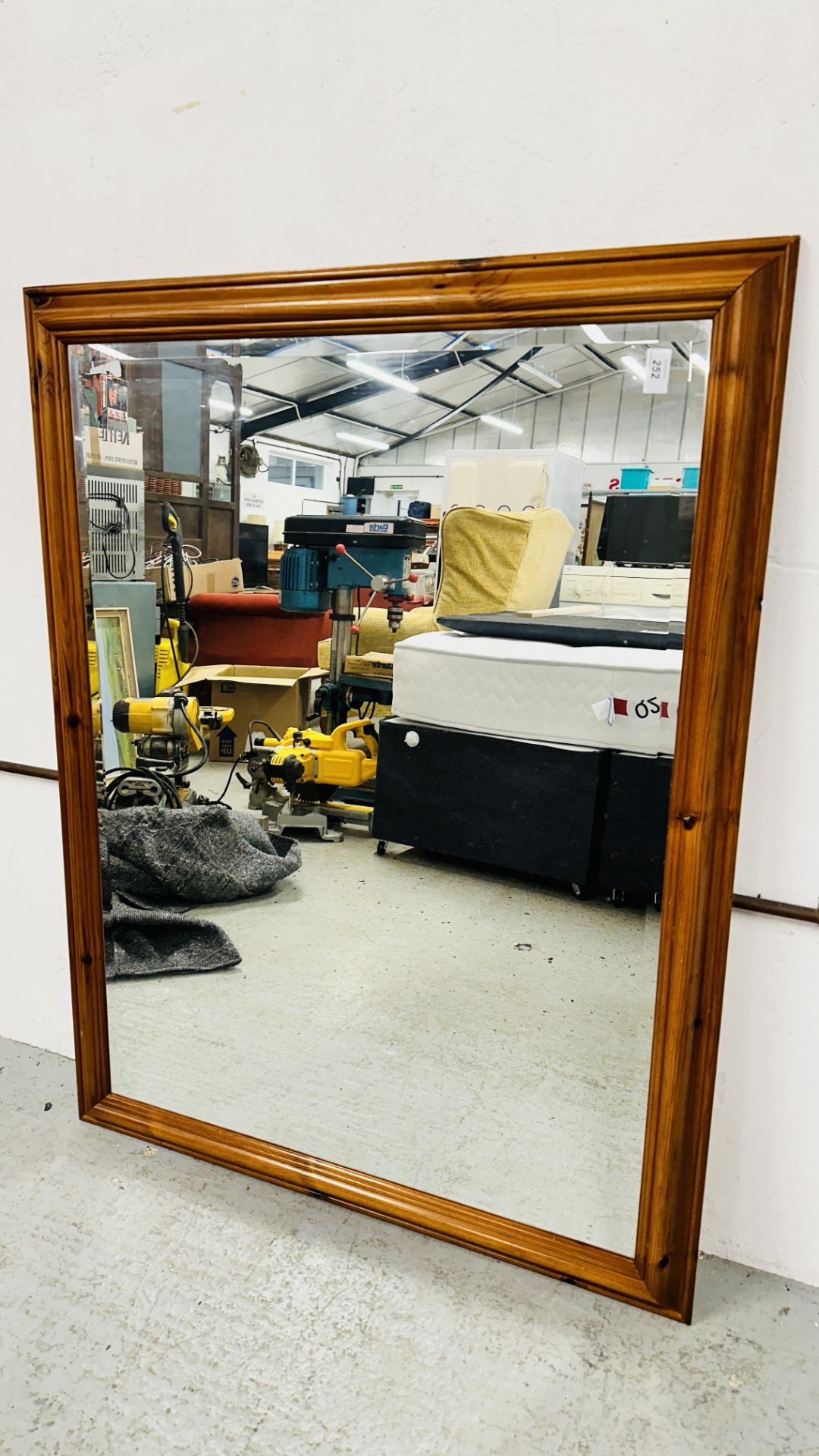 PINE FRAMED WALL MIRROR WITH BEVELLED GLASS.