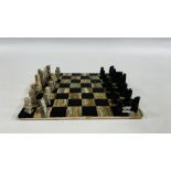 A HARDSTONE CHESS BOARD AND PIECES.
