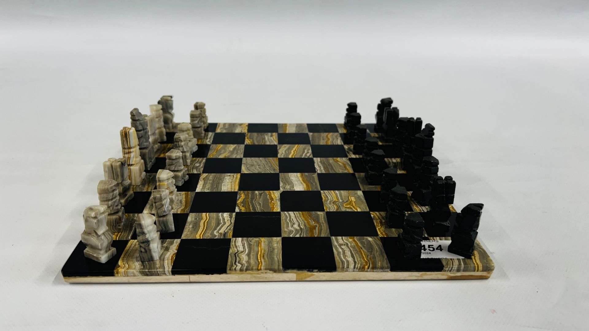 A HARDSTONE CHESS BOARD AND PIECES.