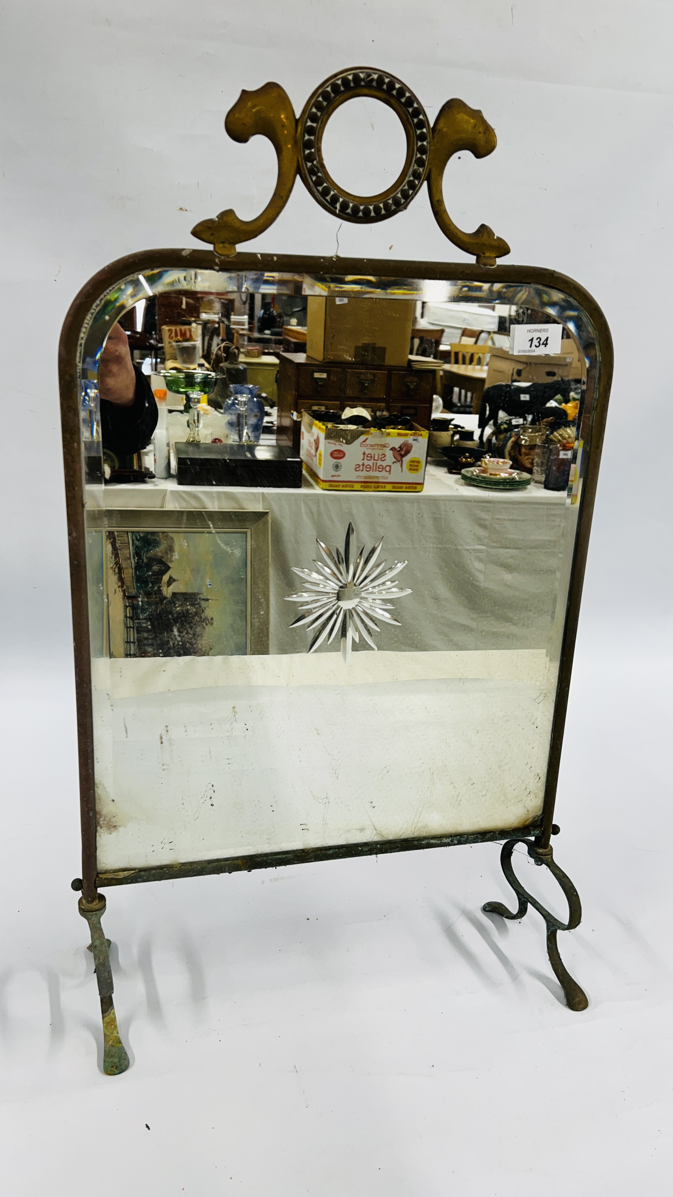ANTIQUE BRASS FRAMED FIRE SCREEN WITH BEVELLED MIRROR INSERT PRESSED DETAIL.
