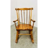 A PINE STICK BACK ROCKING CHAIR.