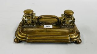 A VINTAGE PLATED DOUBLE INK STAND ON BUN FEET.