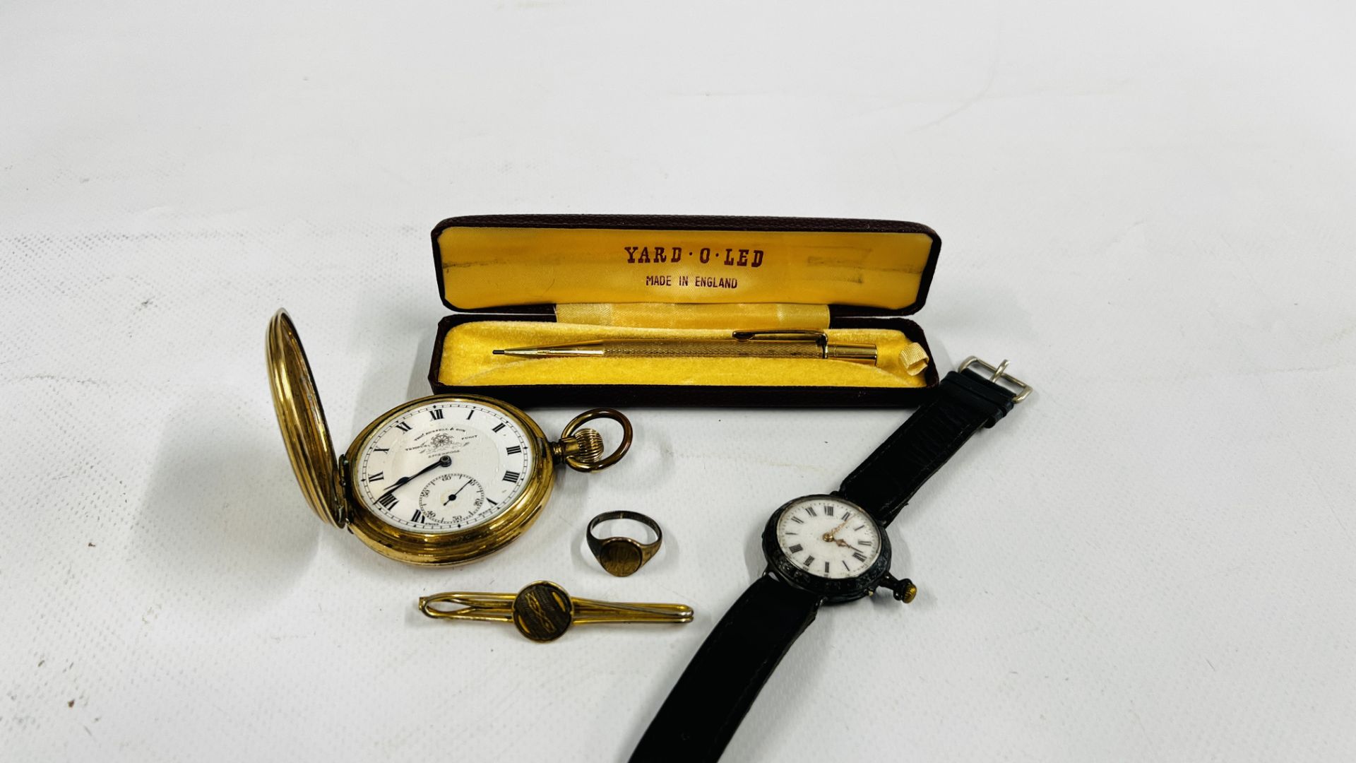 A VINTAGE WHITE METAL CASED WATCH WITH ENAMELED DIAL ON BLACK LEATHER STRAP,