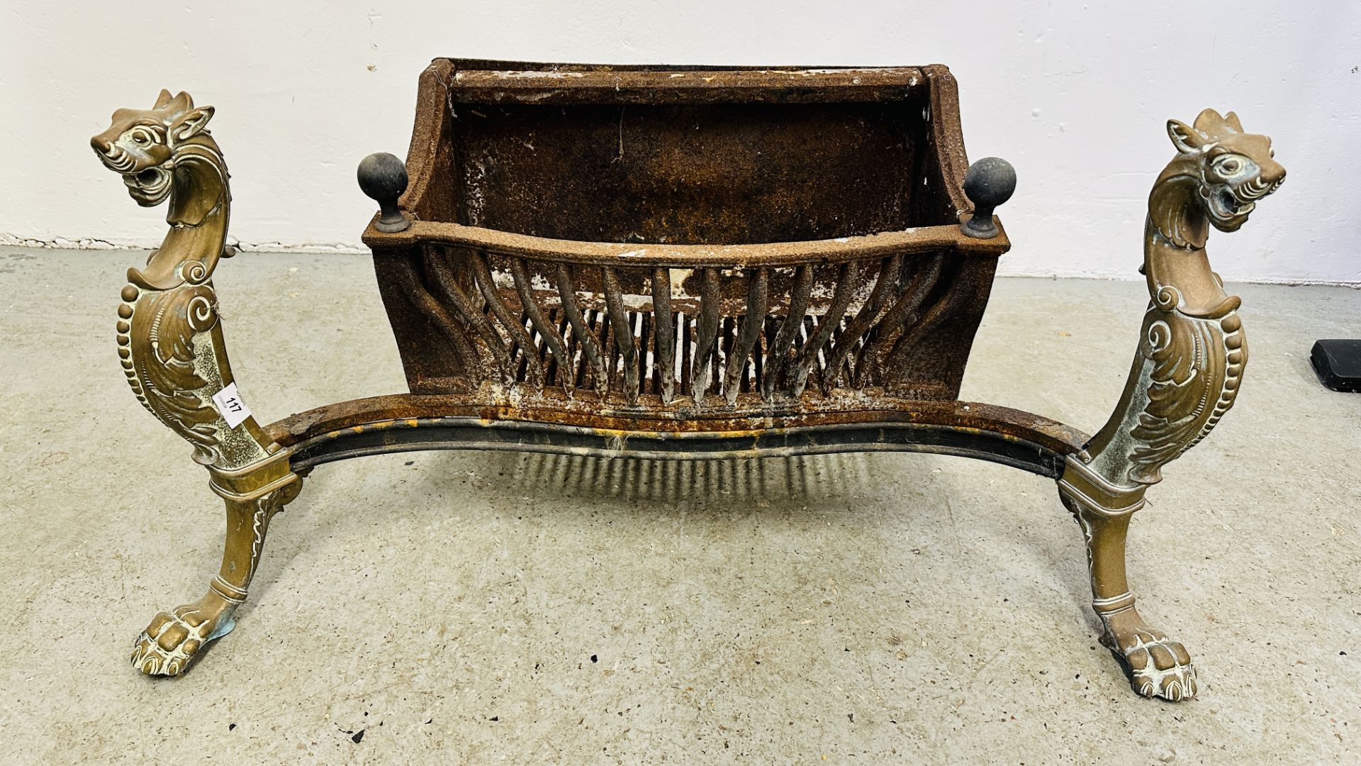 LARGE ANTIQUE CAST IRON FIRE BASKET, THE HEAVY BRASS FORELEGS DETAILED WITH MYTHICAL CREATURES,