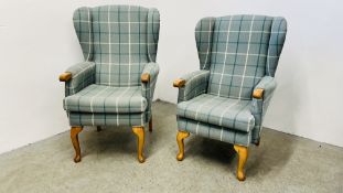 A HIS & HERS SET OF MODERN BLUE CHECKERED UPHOLSTERED BEECH WOOD WING BACK CHAIRS.
