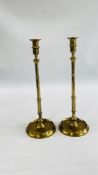 A PAIR OF HEAVY TALL BRASS CANDLESTICKS - HEIGHT 46CM.