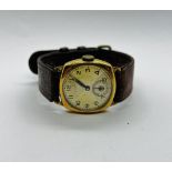A VINTAGE 9CT GOLD CASED WRIST WATCH MARKED HERBERT ....... LTD MAGNO LUX ON A BROWN LEATHER STRAP.