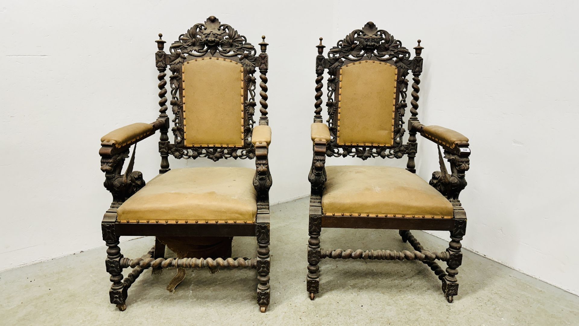 A PAIR OF C1870 HEAVILY CARVED OAK FRAMED OPEN ARM CHAIRS,