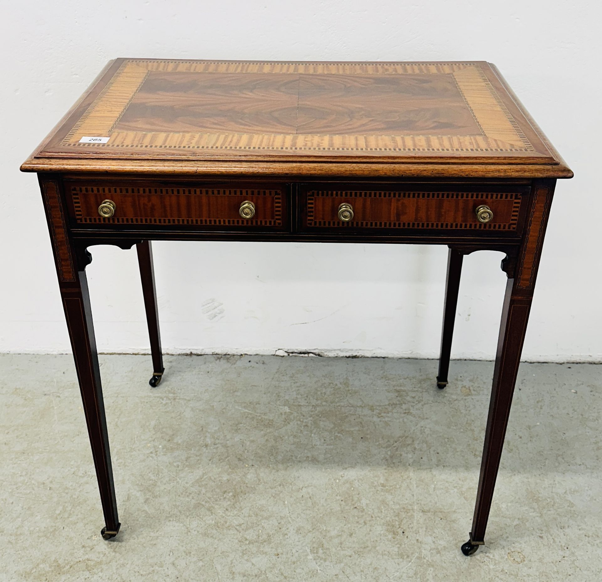 ANTIQUE MAHOGANY & INLAID 2 DRAWER WRITING TABLE WITH BRASS DETAILED HANDLES STANDING ON CASTERS,