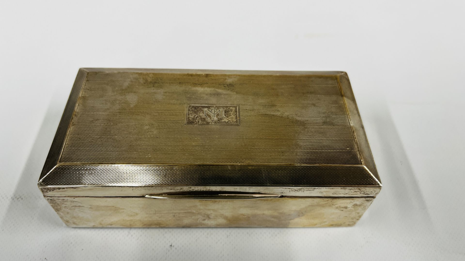 A VINTAGE SILVER CIGARETTE BOX BIRMINGHAM ASSAY J.H.W (RUBBED MARKS) BEARING MONOGRAM MJ 24.7. - Image 2 of 10