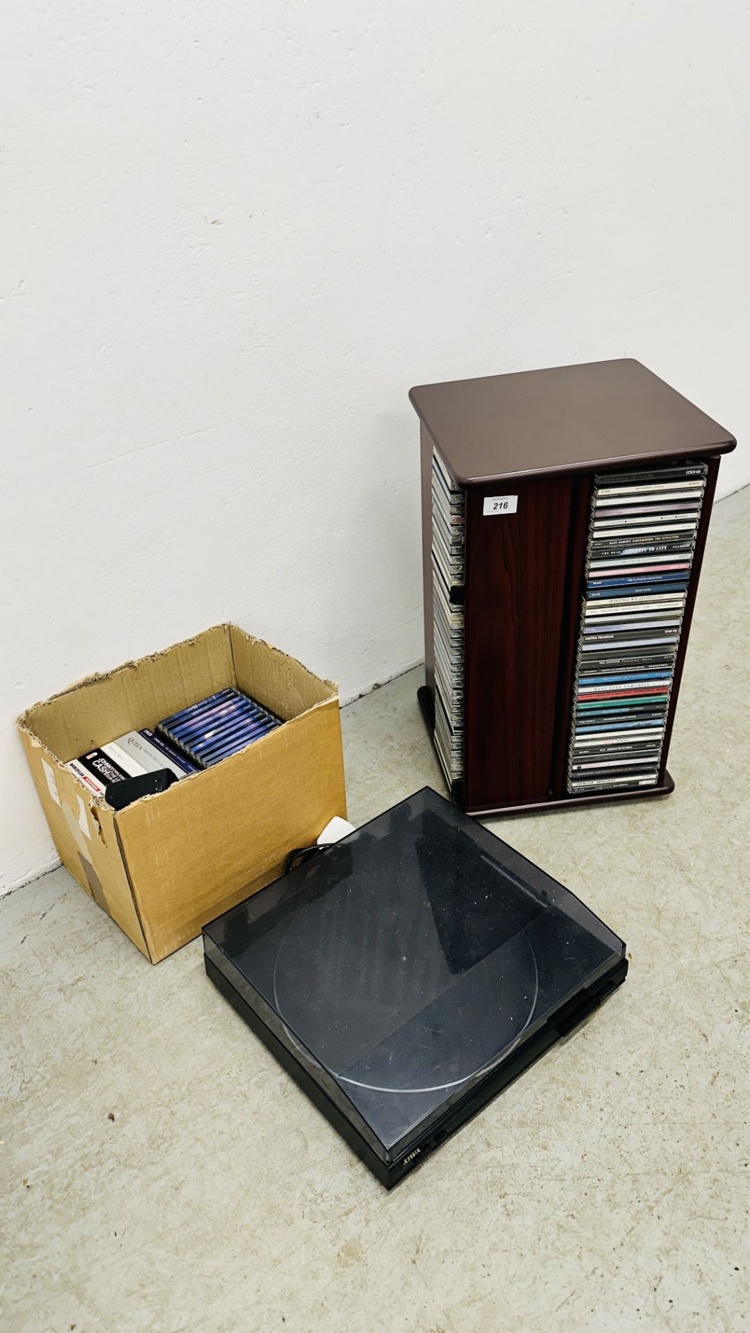 REVOLVING CD STORAGE RACK + QUANTITY MIXED CD'S AND RECORD PLAYER - SOLD AS SEEN.