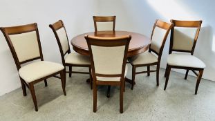 A GOOD QUALITY G PLAN CHERRY WOOD FINISH CIRCULAR EXTENDING DINING TABLE COMPLETE WITH 6 MATCHING