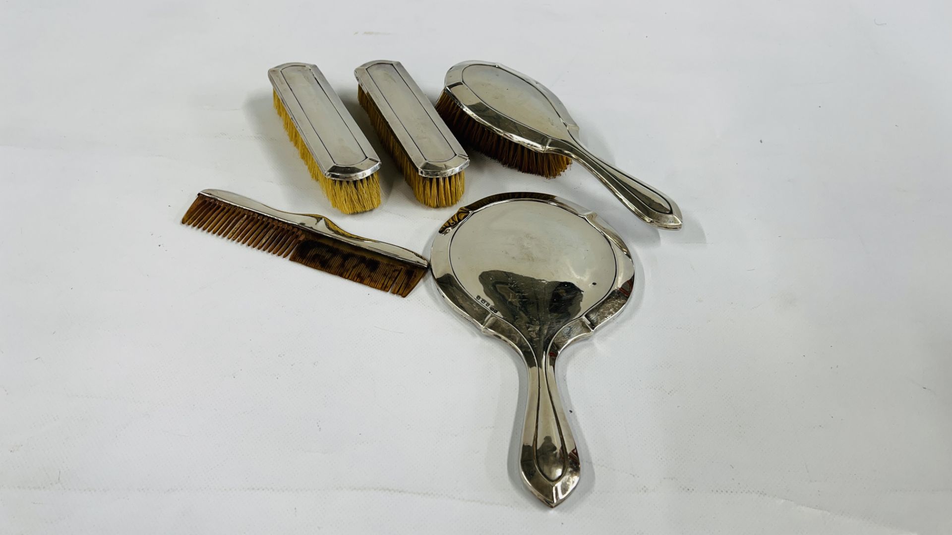 A VINTAGE FIVE PIECE SILVER BACKED DRESSING TABLE SET,
