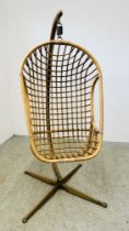 A VINTAGE RATTAN HANGING EGG CHAIR.