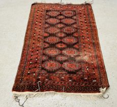 A RED PATTERNED EASTERN RUG 193CM X 125CM.