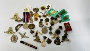 A COLLECTION OF ASSORTED MEDALS AND BADGES TO INCLUDE MANY MILITARY RELATED EXAMPLES.