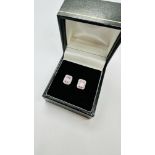 A PAIR OF 9CT GOLD STONE SET DIAMOND EARRINGS.