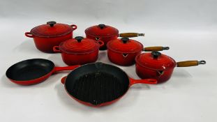 A GROUP OF LE CREUSET RED CAST PANS COMPRISING OF 2 X 2 HANDLED CASSEROLE DISHES AND COVERS,