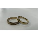 TWO SILVER ENGRAVED HINGED BANGLES BOTH HAVING SAFETY CHAINS.