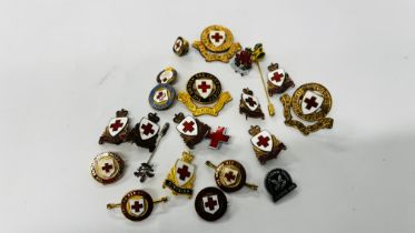 A COLLECTION OF ASSORTED VINTAGE RED CROSS BADGES AND MEDALS TO INCLUDE MANY ENAMELED EXAMPLES.