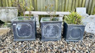 A GRADUATED SET OF THREE SQUARE SLATE EFFECT GARDEN PLANTERS CONTAINING ROSES,