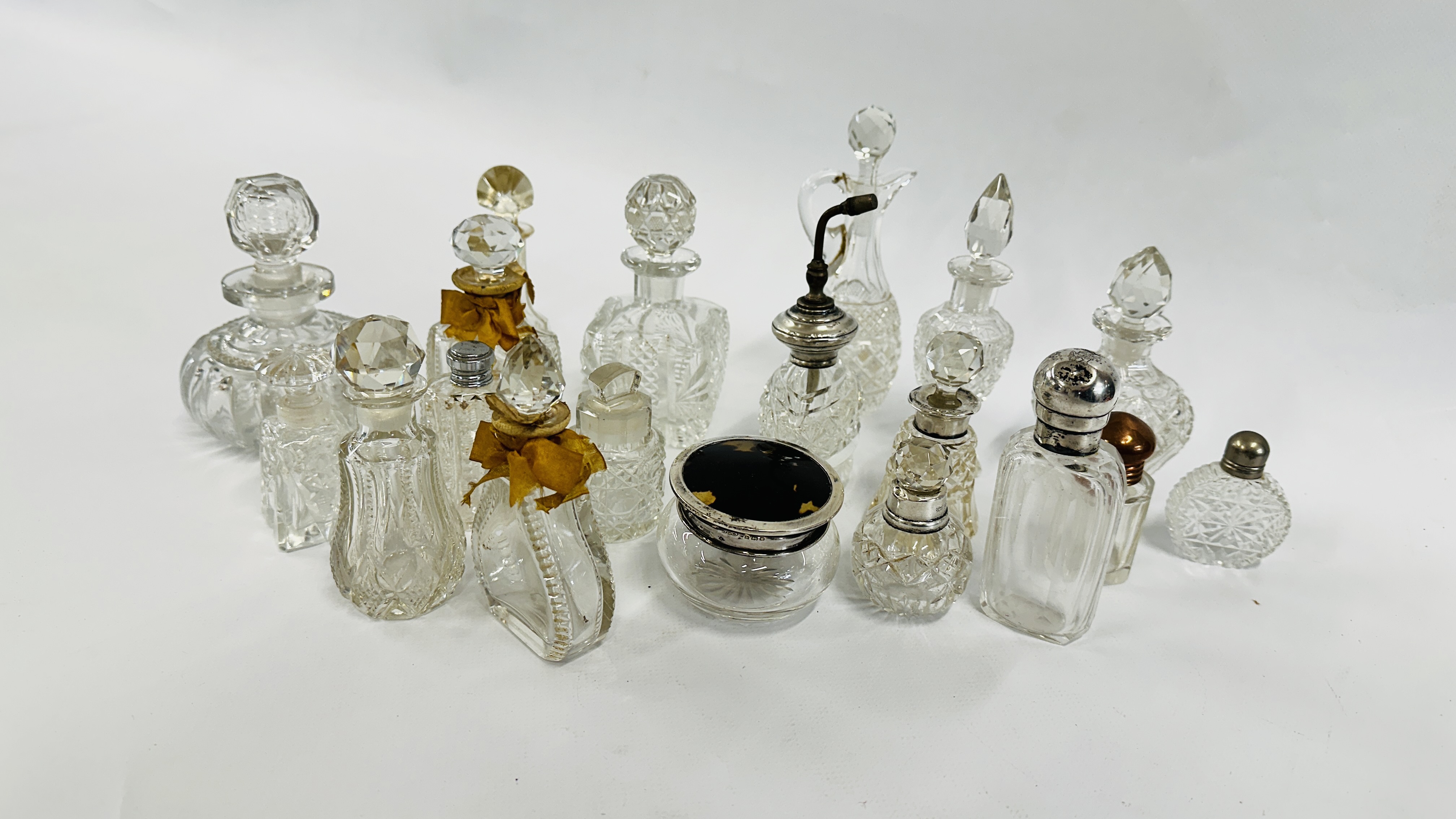 A QUANTITY OF SCENT BOTTLES, SOME SILVER DECORATED.