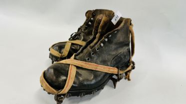 A PAIR OF VINTAGE WORKING/MOUNTAINEERING BOOTS WITH METAL GRIPS.