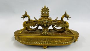 AN ANTIQUE SOLID BRASS INKWELL WITH WINGED DRAGONS AND INTEGRATED PEN TRAY,