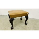 A TAN LEATHERED STOOL STANDING ON SCROLLED LEGS TERMINATING WITH CLAW AND BALL W 60CM D 50CM.
