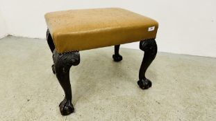 A TAN LEATHERED STOOL STANDING ON SCROLLED LEGS TERMINATING WITH CLAW AND BALL W 60CM D 50CM.