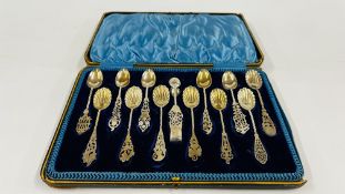 A NOVELTY SET OF TWELVE SILVER TEASPOONS AND NIPS OF ORNATE DESIGN,