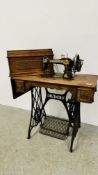 A VINTAGE SINGER TREADLE SEWING MACHINE - SOLD AS SEEN.