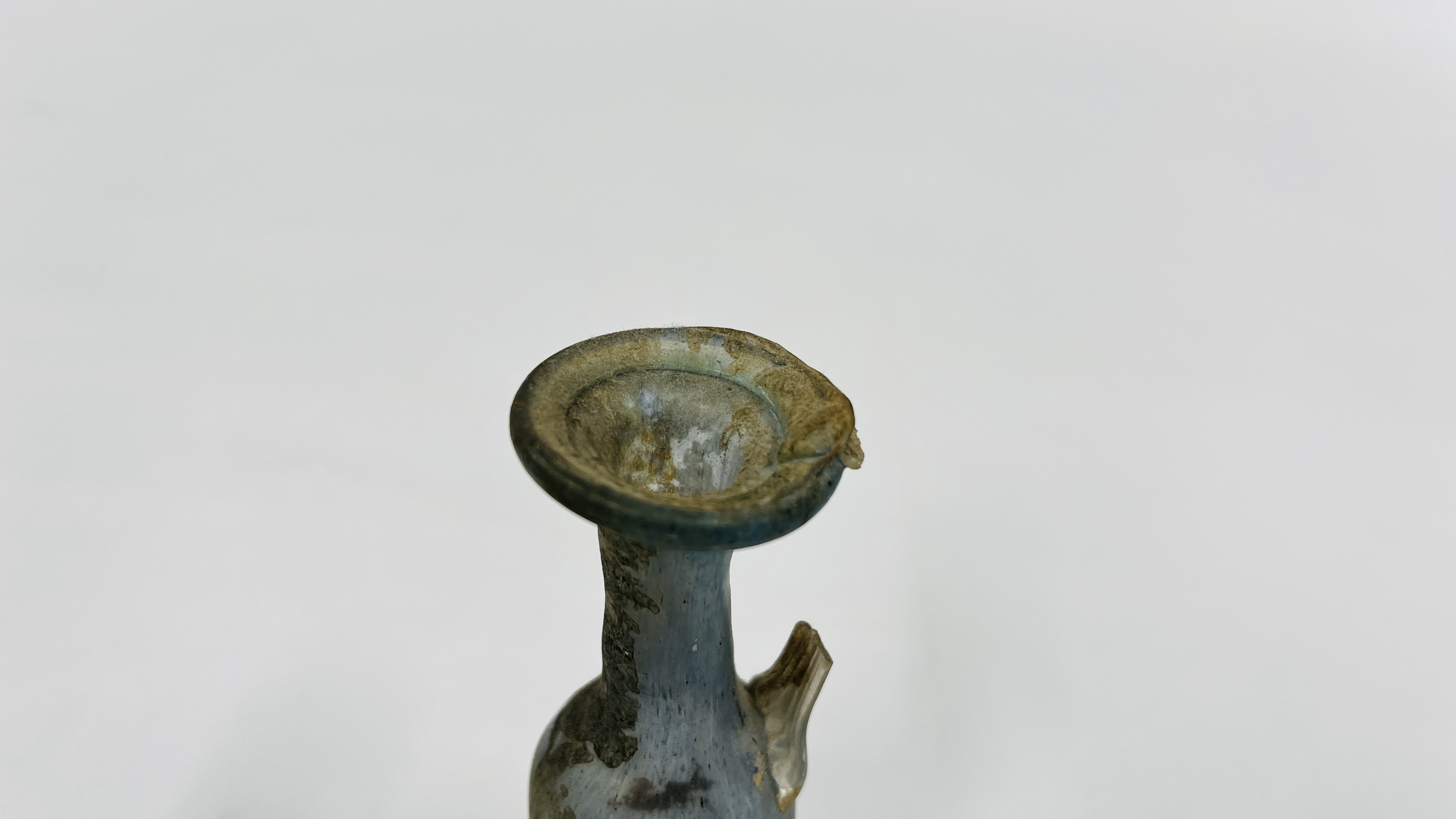 A VINTAGE ROMAN STYLE BOTTLE MOULDED FROM PALE BLUE TRANSLUCENT GLASS A/F H 13CM. - Image 2 of 5