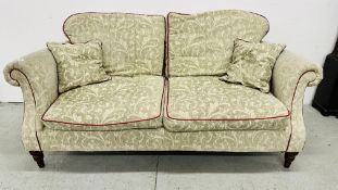 A MODERN CLASSIC DESIGN 2 SEAT SOFA WITH GREEN FLORAL UPHOLSTERY - REQUIRES CLEANING 190CM W.