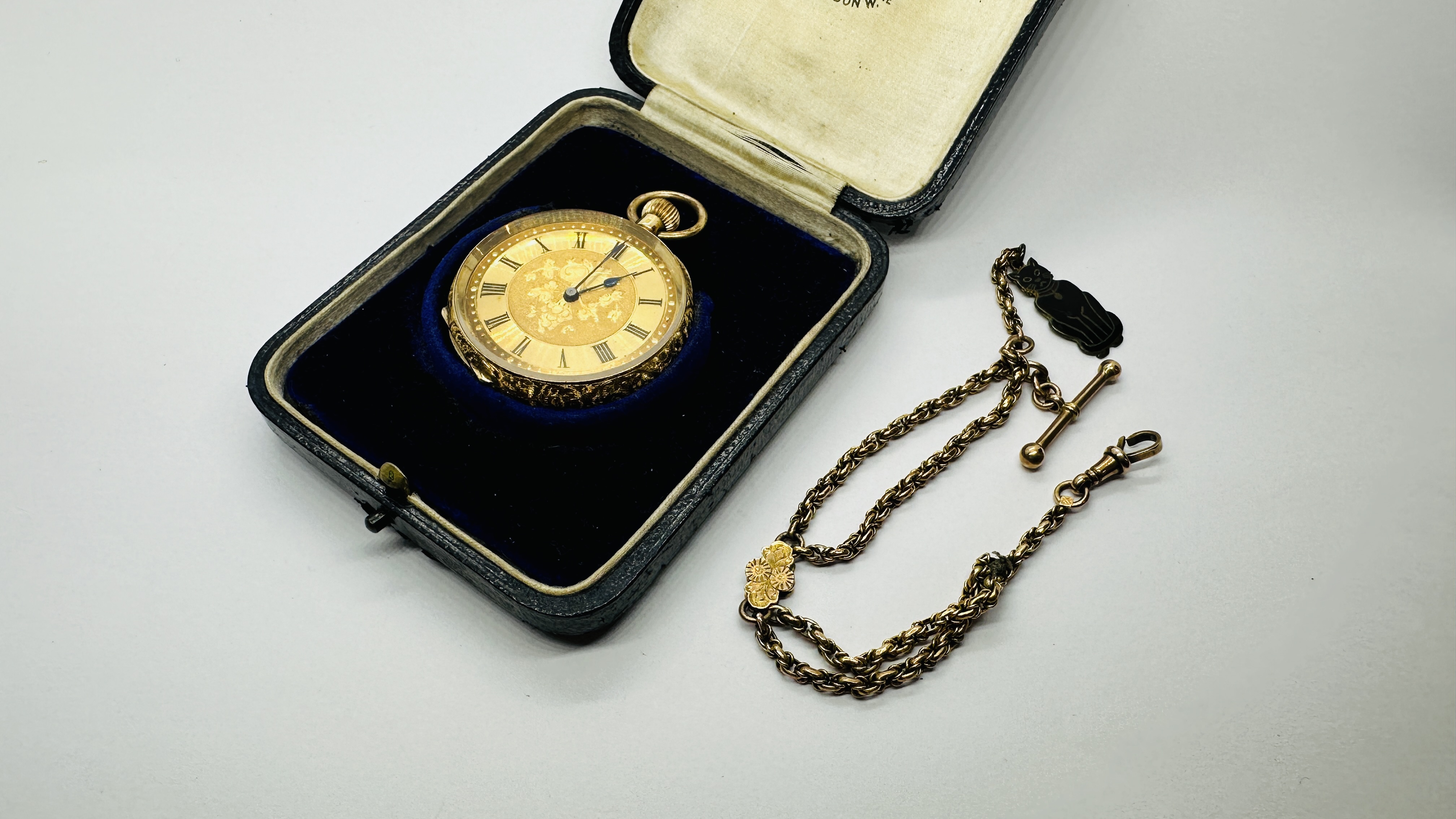 AN ELABORATE ANTIQUE 18CT GOLD CASED HALF HUNTER POCKET WATCH ALONG WITH A WOVEN WATCH CHAIN,