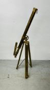 A REPRODUCTION LACQUERED BRASS TELESCOPE FITTED ON A TRIPOD BASE.