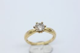 A ROUND BRILLIANT CUT NATURAL DIAMOND SOLITAIRE RING WITH AN INSET DIAMOND EITHER SIDE MARKED 750