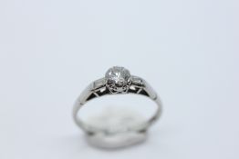 AN 18CT & PLAT DIAMOND SOLITAIRE RING OF RAISED FORM, WITH INSET DIAMOND SHOULDERS.