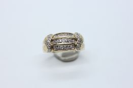 A 9CT GOLD DESIGNER RING SET WITH THREE ROWS OF DIAMONDS.